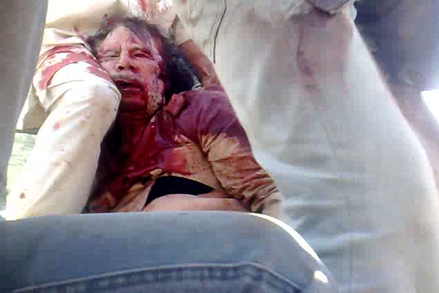 A video grab taken from the mobile phone of a National Transitional Council (NTC) fighter shows the arrest of Libya's strongman Moamer Kadhafi in Sirte on October 20, 2011.   AFP PHOTO/PHILIPPE DESMAZES