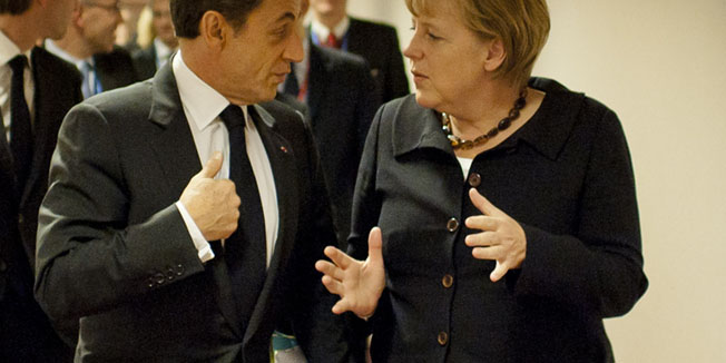 This handout photo made available by the German government press office shows German Chancellor Angela Merkel speaking with French President Nicolas Sarkozy at the EU headquarters in Brussels on October 22, 2011, the day before Europe aimed to nail down a solution to the worst economic crisis in its history, as the spotlight at an emergency meeting of EU leaders fell on Italy amid contagion fears in the eurozone. The two key players, Germany Chancellor Angela Merkel and French President Nicolas Sarkozy, hailed 