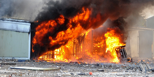 Smoke rises after an explosion in Andst near Kolding, west of Copenhagen  on October 8, 2011. At least one person was killed in a series of explosions which rocked a former military barracks in the town of Andst. AFP PHOTO