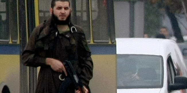 Mevlid Jasarevic (23), stands at an intersection holding an AK-47, after opening fire upon the United States Embassy in Sarajevo, on October 28, 2011. Police acted swiftly and after attempting an arrest, exchanged fire with Jasarevic. The attacker was wounded by Bosnian police, arrested and taken to hospital. His condition is unknown at the moment. AFP PHOTO ELVIS BARUKCIC