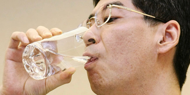 Japan's Parliamentary Secretary for the Cabinet Office Yasuhiro Sonoda drinks a glass of decontaminated water taken from puddles inside the buildings housing reactors 5 and 6 at the Fukushima No. 1 plant during a press conference at Tokyo Electric Power Co. (TEPCO) headquarters in Tokyo on October 31, 2011.      AFP PHOTO/JIJI PRESS