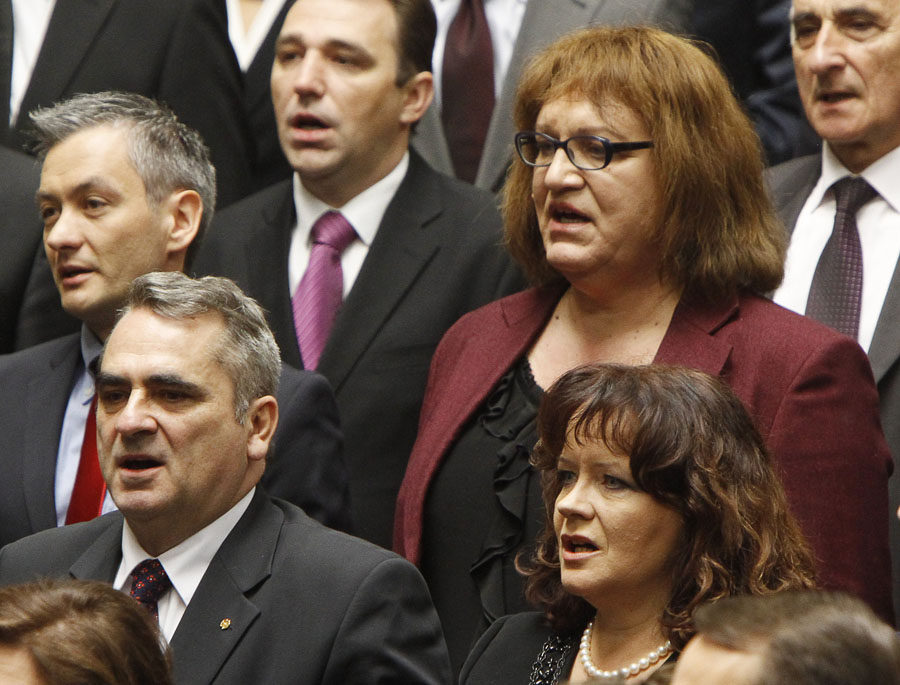 Robert Biedron, back left, the first openly gay Polish lawmaker and Anna Grodzka, second from right in back, the first transsexual lawmaker, both from Palikot's Movement, a new progressive party that became the third-largest party in parliament in Oct. 9 elections, sing the national anthem during the first session of the new Polish Parliament, in Warsaw, Poland, Tuesday, Nov. 8, 2011. (AP Photo/Czarek Sokolowski)