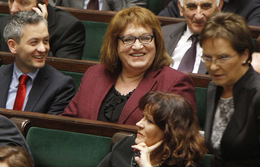 Robert Biedron, left, the first openly gay Polish lawmaker shares a laugh with Anna Grodzka, center, the first transsexual lawmaker, both from Palikot's Movement, a new progressive party that became the third-largest party in parliament in Oct. 9 elections, during the first session of the new Polish Parliament, in Warsaw, Poland, Tuesday, Nov. 8, 2011. (AP Photo/Czarek Sokolowski)
