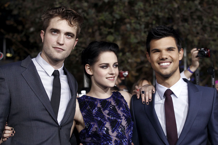 Robert Pattinson, left, Kristen Stewart, center, and Taylor Lautner arrive at the world premiere of 