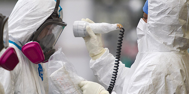 A man is checked for radiation after arriving at a vehicle decontamination center at J-Village, a soccer training complex now serving as an operation base for those battling Japan's nuclear disaster at the tsunami-damaged Fukushima Dai-ichi nuclear plant, in Fukushima prefecture, Japan, Friday, Nov. 11, 2011. (AP Photo/David Guttenfelder, Pool)