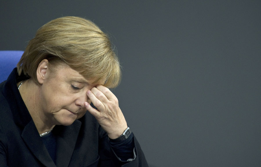 German Chancellor Angela Merkel listens to a speech during a session of Germany's Bundestag lower house of parliament, in Berlin November 23, 2011. Merkel stepped up the pressure on Greece today to commit to reforms, while maintaining her tough stance against the European Commission's plan to introduce eurobonds. AFP PHOTO / JOHN MACDOUGALL