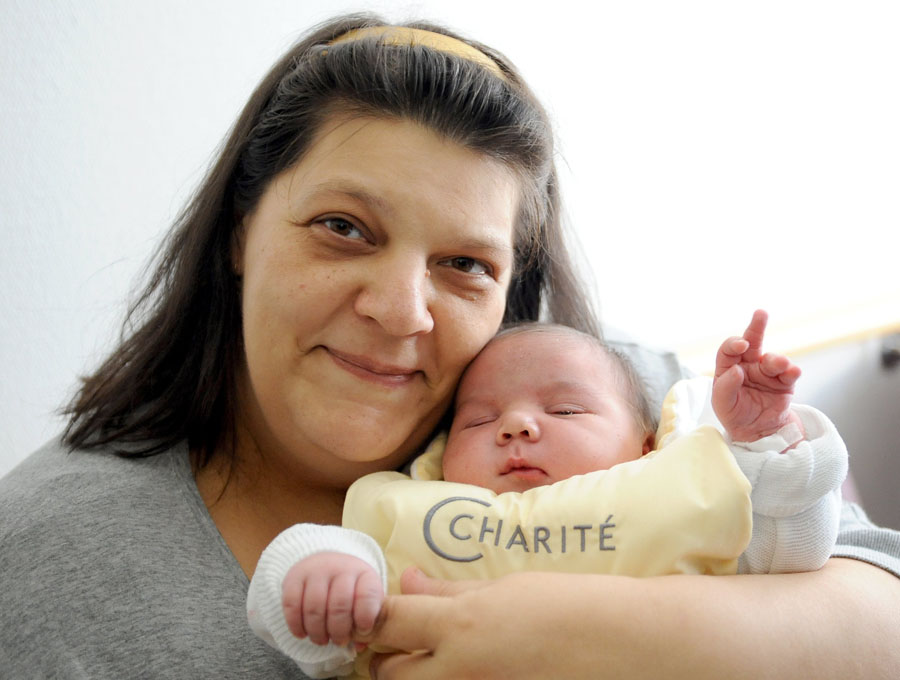 Mother Elfi holds her son 