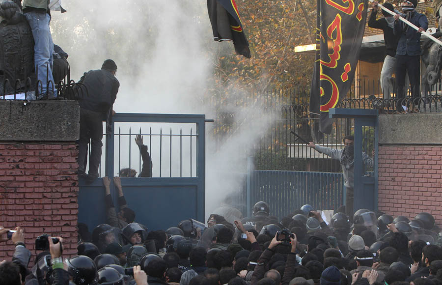 Iranian protestrrs break into the British embassy in Tehran on November 29, 2011.  More than 20 Iranian protesters stormed the British embassy in Tehran, removing the mission's flag and ransacking offices. AFP PHOTO/ATTA KENARE