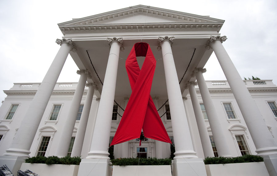 (FILES) A large red ribbon hangs on the North Portico of the White House in Washington in this November 30, 2010, file photo on the eve of World AIDS Day. Nearly three quarters of Americans with HIV do not have their infection under control, raising the risk of death from AIDS and transmission to others, said a US study on November 29, 2011. One in five people with human immunodeficiency virus are unaware that they have the disease, added the report by the Centers for Disease Control and Prevention, released ahead of World AIDS Day on December 1.      AFP PHOTO/Saul LOEB / FILES