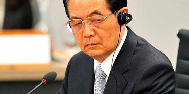 Chinese President Hu Jintao  listens on at the Asia-Pacific Economic Cooperation (APEC) Leaders Summit in Kapolei, Hawaii, on November 13 , 2011. The United States hosts this year's APEC forum for the first time since 1993, with leaders from the 21 member economies convening on the island of Oahu on November 12-13.  AFP PHOTO Jim WATSON