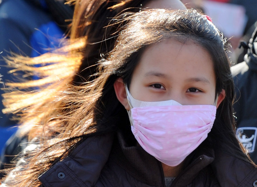 A young Chinese girl wears a face mask to protect against pollution on the streets of Beijing on December 7, 2011. Millions of Chinese have gone online to vent their anger over the thick smog that has blanketed Beijing in recent days, raising health fears and causing hundreds of flights to be cancelled. Sales of face masks were reported to have surged as residents of China's heavily polluted capital sought to protect themselves from the air, which US embassy figures ranked as 