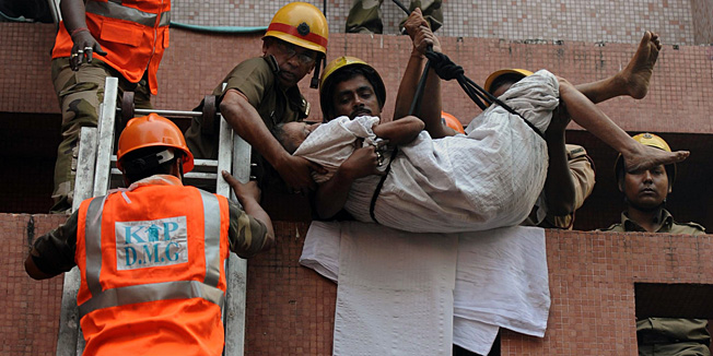 Rescue workers evacuate people after a fire engulfed Amri hospital in the eastern Indian city of Kolkata on December 9, 2011. 