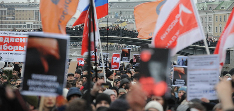 Opposition activists take part in their authorized rally at the Bolotnaya Square  in central Moscow, on December 10, 2011, to  protest against the alleging mass fraud in the December 4 parliamentary polls.Tens of thousands of election protesters turned out today in Moscow and other major cities across Russia in open defiance to strongman Vladimir Putin's 12-year rule. AFP PHOTO / YURI KADOBNOV