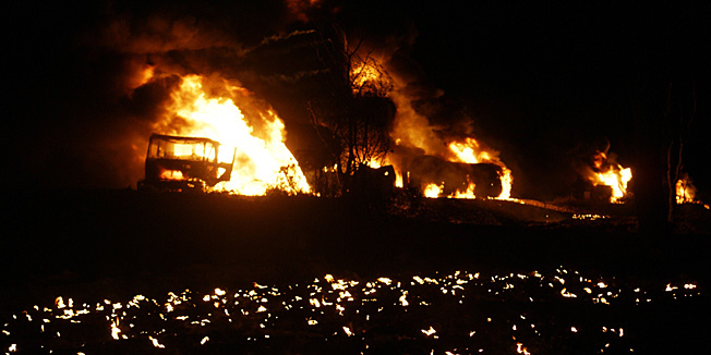 Flames rise from the burning NATO supply oil tankers following an attack by gunmen in Dadar town of Bolan district, about 90 kilometres southwest of Quetta, the provincial capital of Baluchistan late on December 11, 2011. Gunmen killed a NATO truck driver and burnt seven tankers carrying oil for Western troops in Afghanistan, the second such attack in southwest Pakistan in less than a week, police said. The convoy was attacked while returning to the port city Karachi from the Afghan border, which Pakistan shut to NATO supplies on November 26 after NATO air strikes killed 24 Pakistani soldiers. AFP PHOTO / STR