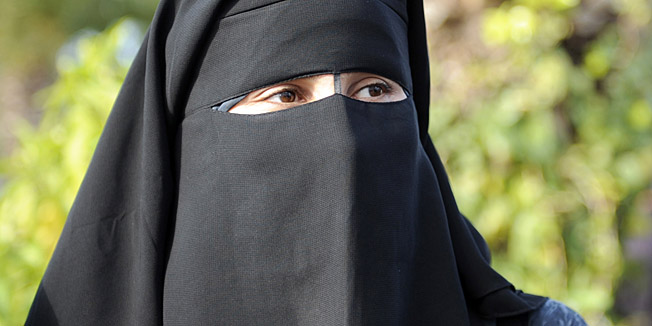 A female student, wearing a niqab, attends a demonstration outside the Faculty of Arts in Manuba, some 25 kms west of Tunis, on December 8, 2011. Several hundred demonstrators gathered at the university calling for women to be allowed to wear the Muslim veil in class and pass exams. A group of Salafists disrupted classes on November 28 at the university, demanding a stop to mixed-sex classes and for female students to wear full face veils. AFP PHOTO / FETHI BELAID