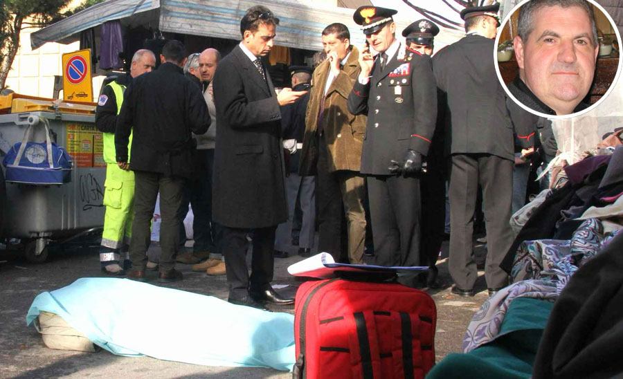 Policemen stand by bodies of two Senegalese vendors who were killed on a market on December 13, 2011 in Florence. An Italian far-right militant Tuesday killed two Senegalese vendors and wounded three people in a shooting spree in broad daylight in Florence after which he was found shot dead.  AFP PHOTO / STR