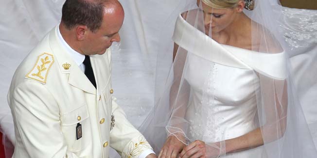 Prince Albert II of Monaco puts the ring on Princess Charlene of Monaco finger during their religious wedding at the Main Courtyard of the Prince's Palace on July 2, 2011 in Monaco.  AFP PHOTO / VALERY HACHE