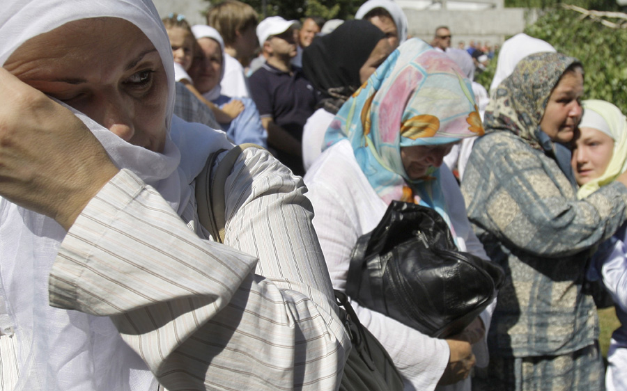 Bosnian Muslim women crying during a farewell ceremony for the caskets of 614 Srebrenica massacre victims, near Visoko city morgue, Bosnia on Saturday, July 9, 2011. Bodies were prepared for mass burial ceremony scheduled on July 11, at Potocari Memorial Cemetery in Srebrenica. This year's mass burial, marking the 16th anniversary of the fall of Srebrenica, is organized for 614 bodies, collected from mass grave sites in eastern Bosnia. In previous years, more than 4,500 bodies were buried at Srebrenica Memorial Cemetery, after being excavated from mass graves in eastern-Bosnia and positively identified.(AP Photo/Amel Emric)