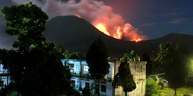 The Lokon volcano erupts near Tomohon on July 15, 2011. The Indonesian volcano erupted late July 14, spewing rocks, lava and ash hundreds of metres into the air, an official said, three days after its alert status was raised to the highest level. There has been a significant rise in volcanic activity at Mount Lokon on Sulawesi Island since June 9, prompting hundreds of people to evacuate the area. AFP PHOTO / TENGKU