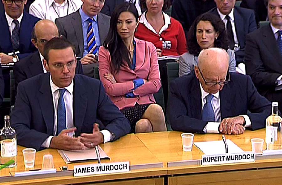 ATTENTION EDITORS: THIS IMAGE MUST NOT BE USED AFTER 1600 GMT ON JULY 20, 2011A screen grab image taken in London on July 19, 2011, shows News Corporation Chief Rupert Murdoch (Front R) and his son James (Front L) giving evidence to a Parliamentary Select Committee on the phone hacking scandal, as Rupert Murdoch's wife Wendi Deng (C) looks on. News Corp chief Rupert Murdoch told British lawmakers 