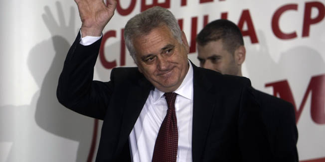 The nationalist Serbian Progressive Party leader, and presidential candidate, Tomislav Nikolic, waves to members of the media at a press conference in Belgrade, Serbia, Sunday, May 6, 2012. A pro European Union candidate and a nationalist opponent are headed for a runoff in Serbia's presidential elections, while the ruling pro Western party is likely to form the next coalition government, independent pollsters said Sunday. (AP Photo/ Marko Drobnjakovic)