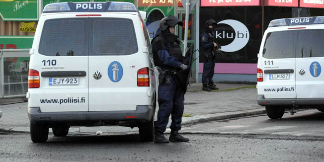 Police officers guard the area in Hyvinkaa, Finland, where a gunman has killed one person and wounded eight others in what appeared to be a random shooting, police said Saturday May 26, 2012. (AP Photo/Lehtikuva/Sari Gustafsson) FINLAND OUT