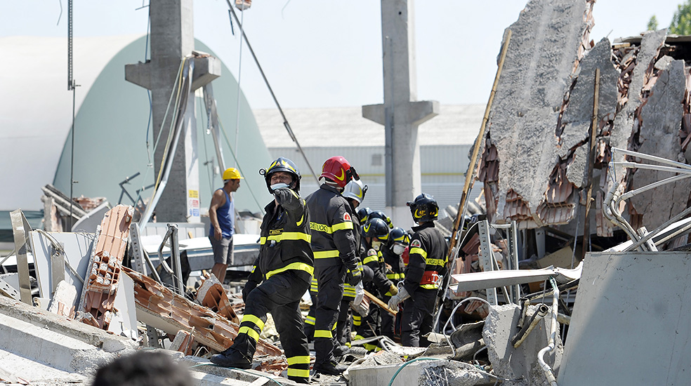 Italian firefighters search the debris of a collapsed factory in Mirandola, northern Italy, Tuesday, May 29, 2012. A magnitude 5.8 earthquake struck the same area of northern Italy stricken by another fatal tremor on May 20. (AP Photo/Marco Vasini)