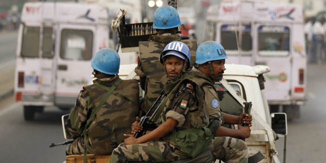 FILE- In this Jan. 10, 2011 file photo, United Nations soldiers from Niger conduct a patrol through the streets of Abidjan, Ivory Coast.  Seven U.N. peacekeepers from Niger were killed in an ambush Friday, June 8, 2012 in a remote area of southwestern Ivory Coast while trying to protect civilians threatened by attack, the United Nations said.(AP Photo/Rebecca Blackwell, File)