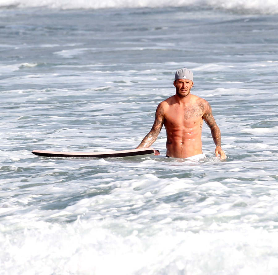 David Beckham was spotted playhing in the wasves with his sons, Brooklyn, Romeo and Cruz.  The super athlete was showing off his tattoos and his ripped abs, on Friday, August 12th, 2011 X17online.com  EXCLUSIVE