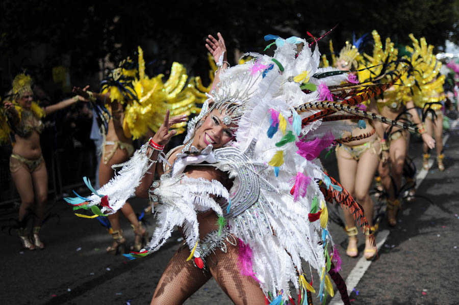 Performers take part in the Notting Hill Carnival in London, on August 29, 2011. Monday, a public holiday, is the second and busiest day of the two-day festival which attracts around one million people, and there are fears gangs could hijack the event and go on the rampage in a repeat of the riots. AFP PHOTO / CARL COURT