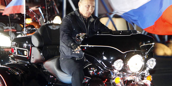 Russian Prime Minister Vladimir Putin rides during a visit to a bike festival in the southern Russian city of Novorossiisk on August 29, 2011. Putin described leather-clad bikers as brothers and boasted of the 