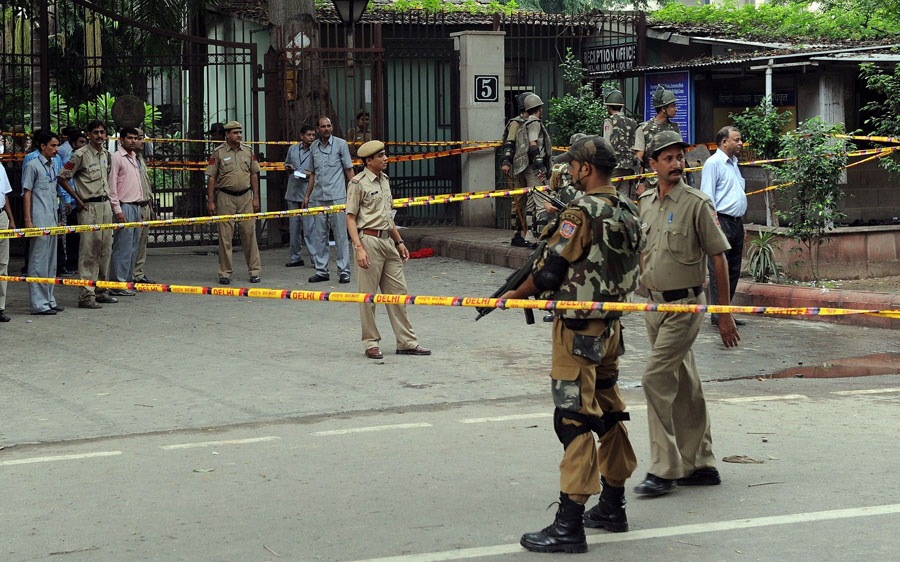 Indian security personnel stand guard outside the reception area of the Delhi High Court at the site of a bomb blast in New Delhi on September 7, 2011. A bomb blast ripped through a crowded reception area at the entrance to New Delhi's High Court in the morning, killing at least nine people and injuring up to 40, police said. Police said the bomb had apparently been placed in a suitcase near the reception where scores of petitioners were queuing for their entry passes to the court complex, situated in the centre of the Indian capital. AFP PHOTO / Prakash SINGH