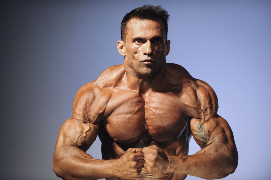 A bodybuilder poses during the IV Sweat Cup body building competition in Caracas on September 11, 2011. AFP PHOTO/LEO RAMIREZ