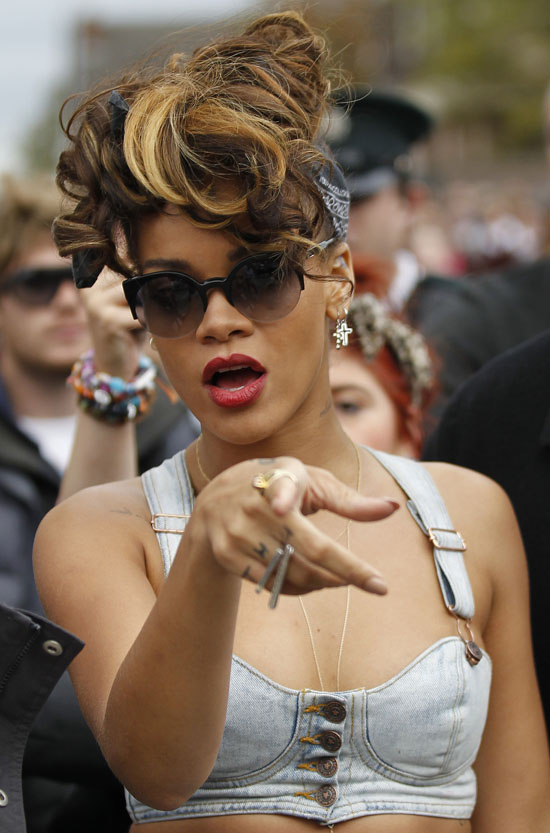 Pop star Rihanna talks to photographers during a break in filming in the New Lodge area of north Belfast, Northern Ireland, Tuesday, Sept. 27, 2011.  (AP Photo/Peter Morrison)