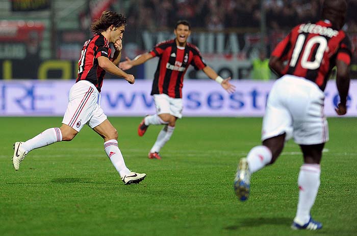 A.C. Milan's midfielder Andrea Pirlo (L) celebrates after scoring during their Italian serie A football match between Parma Fc and AC Milan at the Ennio Tardini stadium in Parma on October 2, 2010.  AFP PHOTO / ALBERTO PIZZOLI