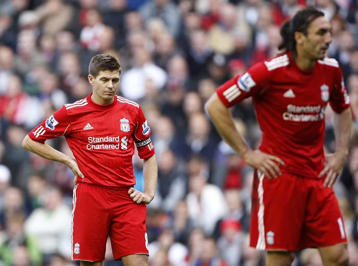 Liverpool's Steven Gerrard, left, and Sotirios Kyrgiakos react against Blackpool during their English Premier League soccer match at Anfield, Liverpool, England, Sunday Oct. 3, 2010. (AP Photo/Tim Hales) ** NO INTERNET/MOBILE USAGE WITHOUT FOOTBALL ASSOCIATION PREMIER LEAGUE (FAPL) LICENCE. CALL +44 (0) 20 7864 9121 or EMAIL info@football-dataco.com FOR DETAILS **