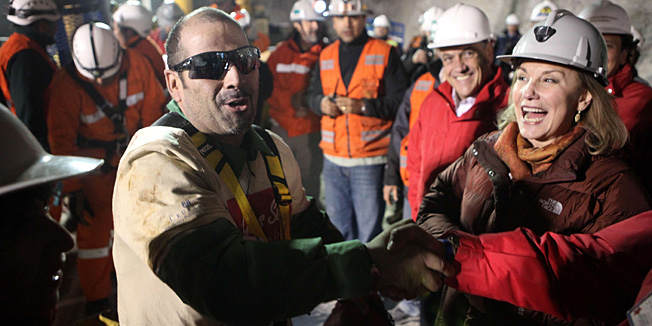 Chilean miner Mario Sepulveda (L) celebrates with Chilean first lady Cecilia Morel (R) after being brought to the surface on October 13, 2010 following a 10-week ordeal in the collapsed San Jose mine, near Copiapo, 800 km north of Santiago, Chile. Sepulveda was the second of 33 miners to arrive at the surface.  MANDATORY CREDIT AFP PHOTO/ HUGO INFANTE/GOVERNMENT OF CHILE - RESTRICTED TO EDITORIAL USE - NOT FOR SALE FOR MARKETING OR ADVERTISING CAMPAIGN