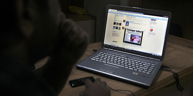 A Kashmiri youth reads a news item posted on his Facebook page in an Internet cafe in Srinagar, India, Friday, Aug. 27, 2010. With student discussion groups banned and thousands of security operatives believed to be snooping on protesters, a wave of Web-savvy protesters in Indian-controlled Kashmir have begun using social networking to publicize their fight and keep fellow demonstrators energized and focused. The protesters who call themselves 