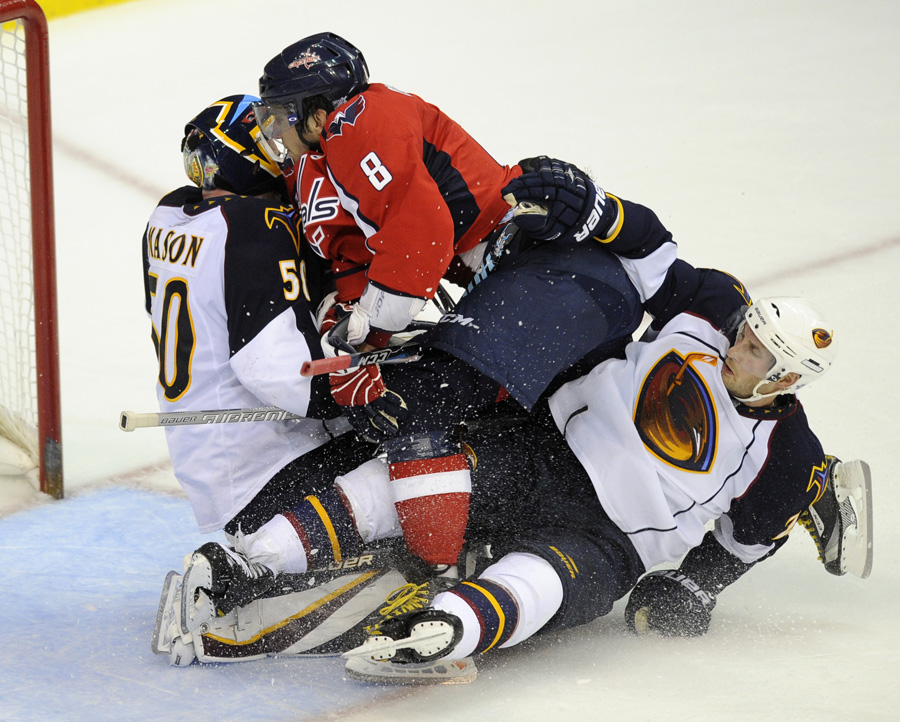 Washington Capitals left wing Alex Ovechkin (8), of Russia, collides with Atlanta Thrashers goalie Chris Mason, left, and Freddy Meyer, right, during the third period of an NHL hockey game, Saturday, Oct. 23, 2010, in Washington. The Capitals won 4-3 in overtime. (AP Photo/Nick Wass)