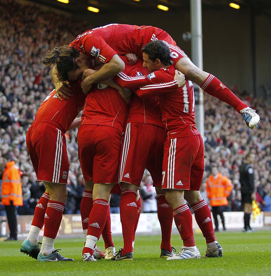 Liverpool's Spanish player Fernando Torres (C) celebrates scoring his goal against Blackburn Rovers with Liverpool's Greek player Sotirios Kyrgiakos  (top) and team mates during a Premier League match at Anfield in Liverpool,  England on October 24, 2010. AFP PHOTO/IAN KINGTONFOR EDITORIAL USE ONLY Additional licence required for any commercial/promotional use or use on TV or internet (except identical online version of newspaper) of Premier League/Football League photos. Tel DataCo +44 207 2981656. Do not alter/modify photo.