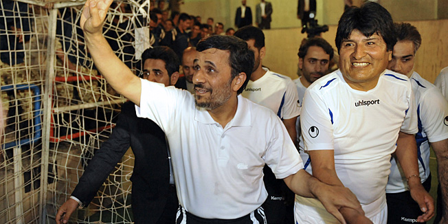 In this picture taken on Tuesday, Oct. 26, 2010, Iranian President Mahmoud Ahmadinejad, left, holds the hand of his Bolivian counterpart, Evo Morales, prior to a friendly Fursal, in Tehran, Iran. (AP Photo/ISNA, Amir Kholousi)