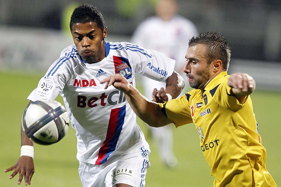 Lyon's Michel Bastos of Brazil, left, challenges for the ball with Sochaux's David Sauget, right, during their French League One soccer match at Gerland stadium, in Lyon, central France, Saturday, Oct. 30, 2010. (AP Photo/Laurent Cipriani)