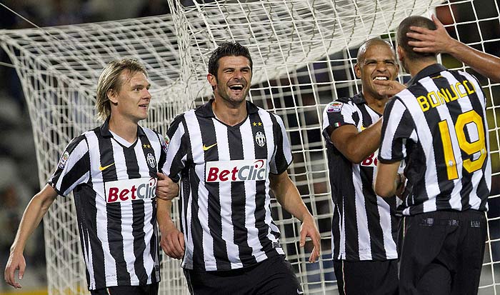 Juventus' players from left, Milos Krasic, Vincenzo Iaquinjta, and Felipe Melo celebrate with Leonardo Bonucci, right, back to camera, after he scored his side's third goal during a Serie A soccer match between Juventus and Caglari in Turin, Italy, Sunday, Sept. 26, 2010. Juventus won 4-2.  (AP Photo/Alberto Ramella)