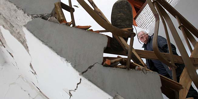 A man looking his damaged apartment building in Kraljevo, about 130 kilometers south of Belgrade, was damaged in the earthquake early Wednesday, Nov. 3, 2010. The 5.3 magnitude earthquake hit central Serbia early Wednesday killing a few and injuring dozens. (AP Photo/Darko Vojinovic)