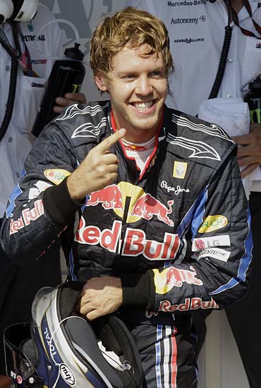 Red Bull driver Sebastian Vettel of Germany celebrates after winning the Brazilian Formula One Grand Prix at the Interlagos race track in Sao Paulo, Brazil, Sunday, Nov. 7, 2010. (AP Photo/Luca Bruno)