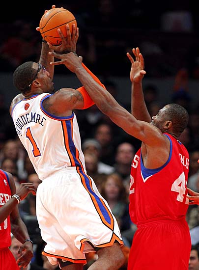 New York Knicks' Amare Stoudemire (1) is fouled by Philadelphia 76ers' Elton Brand (42) late in the fourth quarter of an NBA basketball game at Madison Square Garden in New York, Sunday, Nov. 7, 2010. 76ers won 106-96. (AP Photo/Paul J. Bereswill)