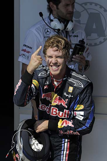 German Red Bull Racing driver Sebastian Vettel reacts after winning the Brazilian Grand Prix at Interlagos circuit in Sao Paulo, on November 7, 2010. Sebastian Vettel led a Red Bull one-two at the Brazilian Grand Prix on Sunday finishing ahead of team-mate Mark Webber. World Championship leader Fernando Alonso in a Ferrari was third and he will start next week's final race in Abu Dhabi eight points ahead of Webber and 15 points ahead of Vettel. The result saw Red Bull crowned constructors champions for the first time. AFP PHOTO/Mauricio LIMA
