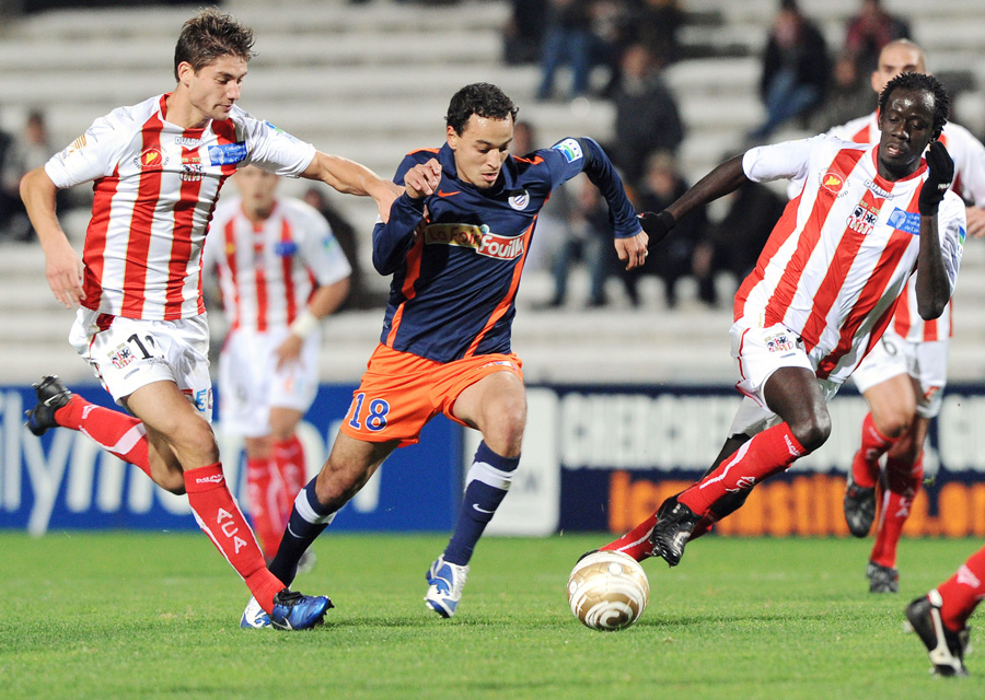 Montpellier's midfielder Karim Ait Fana (C) vies with Ajaccio's midfielder Paul Lasne (L) and defender Fousseni Diawara (R) during the French League cup football match Montpellier vs.Ajaccio, on Octoberr 26, 2010 at the La Mosson stadium in Montpellier, southern France.  AFP PHOTO / PASCAL GUYOT