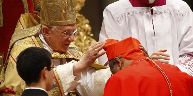 Newly-elevated Sri Lankan Cardinal Albert Malcom Ranjith Patabendige Don, right, receives the red three-cornered biretta hat by Pope Benedict XVI during a consistory inside St. Peter's Basilica, at the Vatican, Saturday, Nov. 20, 2010. Benedict XVI formally created 24 new cardinals on Saturday amid cheers in St. Peter's Basilica, bringing a mostly Italian group into the elite club that will eventually elect his successor. (AP Photo/Pier Paolo Cito)