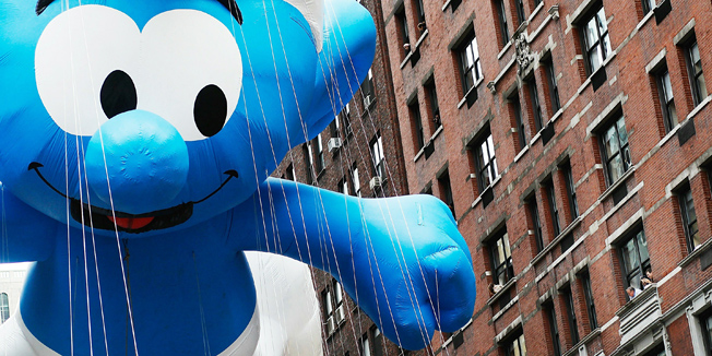 NEW YORK - NOVEMBER 25: The Smurf float passes by people watching from apartments and offices on Seventh Avenue, heading south to Times Square during the Macy's Thanksgiving Day parade November 25, 2010 in New York City. The 84th annual celebration featured approximately 8,000 participants including more 1,600 cheerleaders and dancers, twelve marching bands, and an assortment of celebrities in addition to 15 giant character balloons.   Chris Hondros/Getty Images/AFP== FOR NEWSPAPERS, INTERNET, TELCOS & TELEVISION USE ONLY ==
